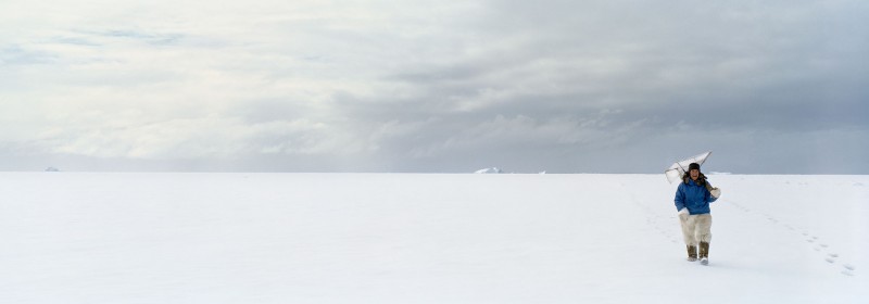 Unartoq, 27.5" x 79", a hunter returns from the ice carrying his seal blind