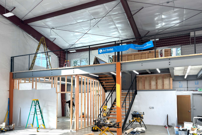 The interior of a warehouse with a partially framed wall